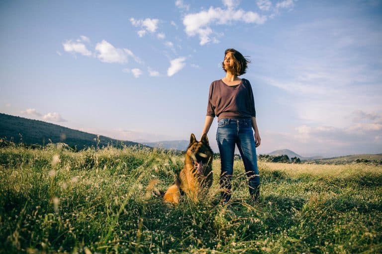 Woman and her Protection Dog German Shepherd enjoying the spring breeze