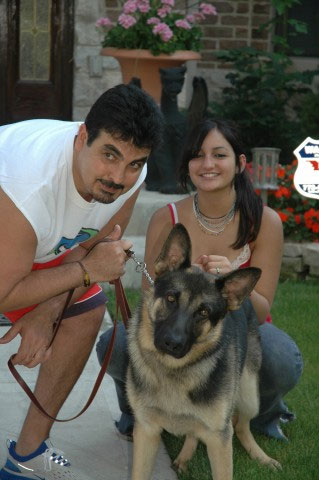 A happy family posing with their Protection Dog.