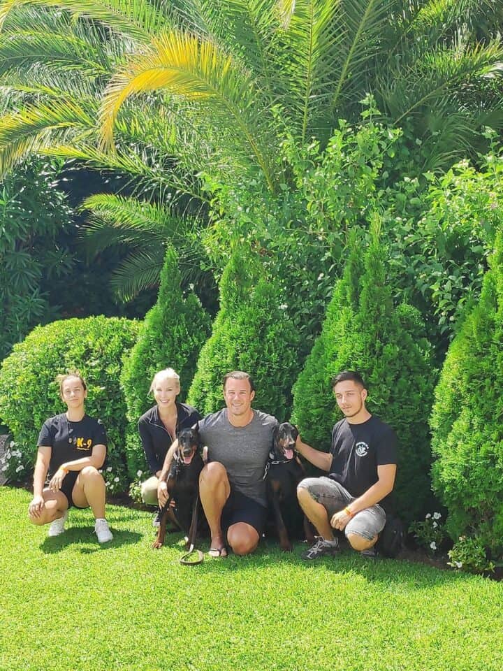 European Doberman with owners and their trainers