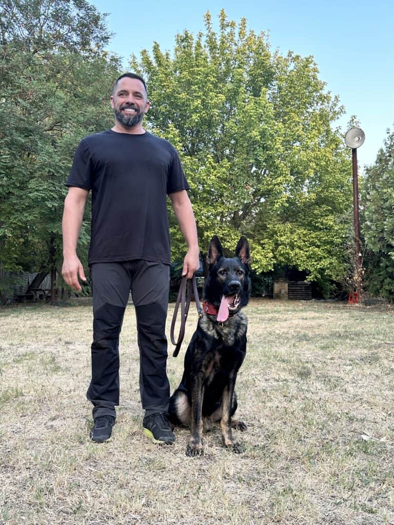 Laszlo Pek Mrazovac and an Executive Personal Protection Dog standing on a grass